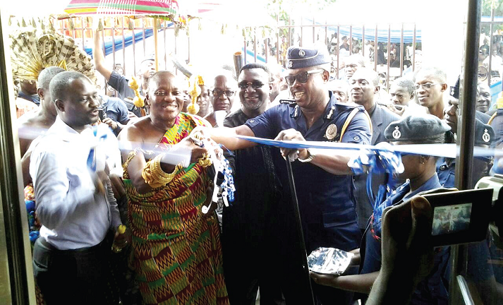 Nana Otuo Siriboe II (2nd left) being assisted by COP Mr Kofi Boakye and other dignitaries to cut the tape to inaugurate the building (inset) Nana Otuo Siriboe II (2nd left) being assisted by COP Mr Kofi Boakye and other dignitaries to cut the tape to inaugurate the building (inset)